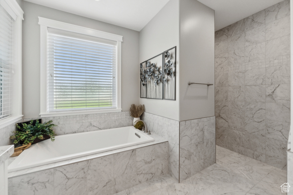 Bathroom featuring tiled bath