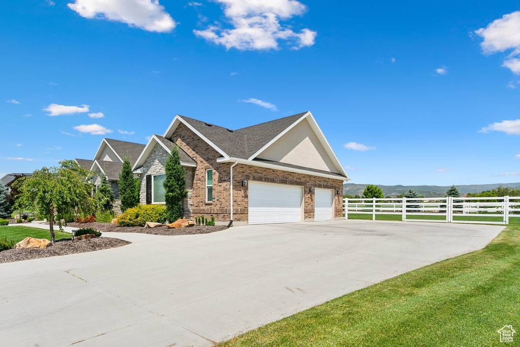 View of front of property with a garage and a front yard