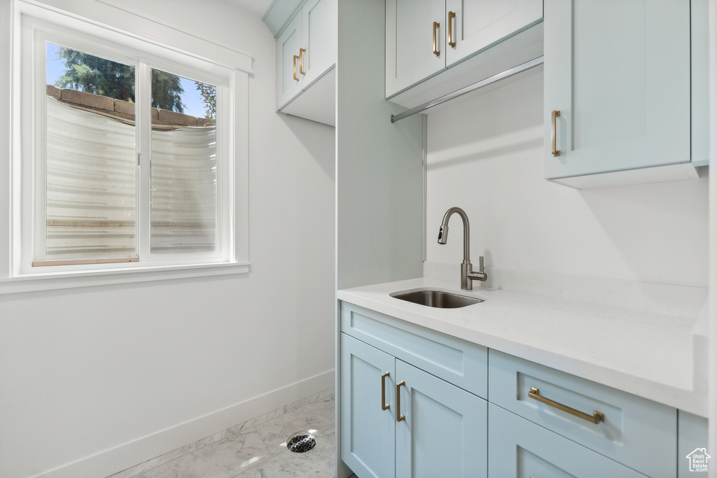 Clothes washing area featuring sink