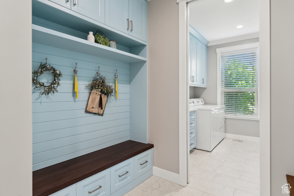 Mudroom featuring independent washer and dryer and light tile patterned floors