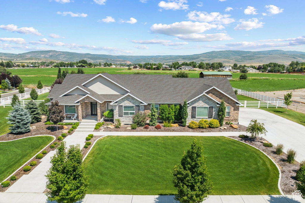 Ranch-style house with a mountain view and a front yard