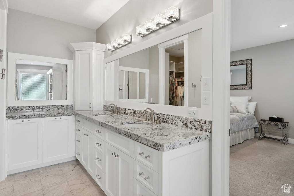 Bathroom with tile patterned floors and double sink vanity