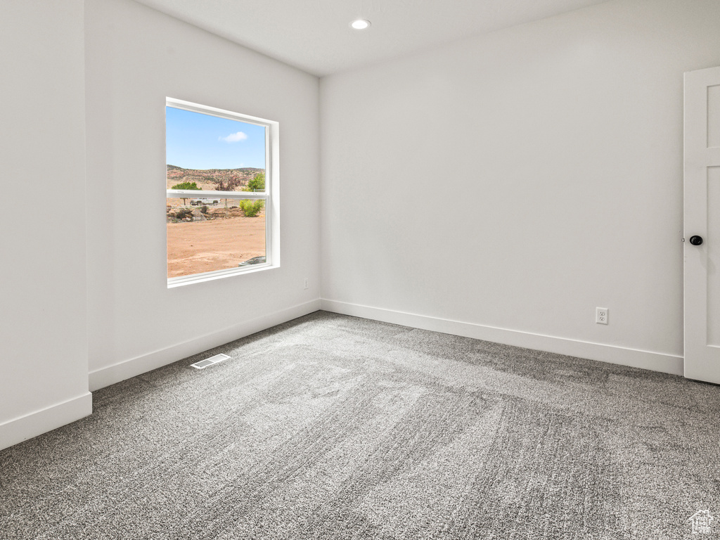 Spare room featuring carpet