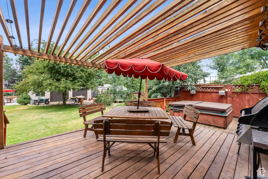 Wooden terrace with a covered hot tub and a pergola