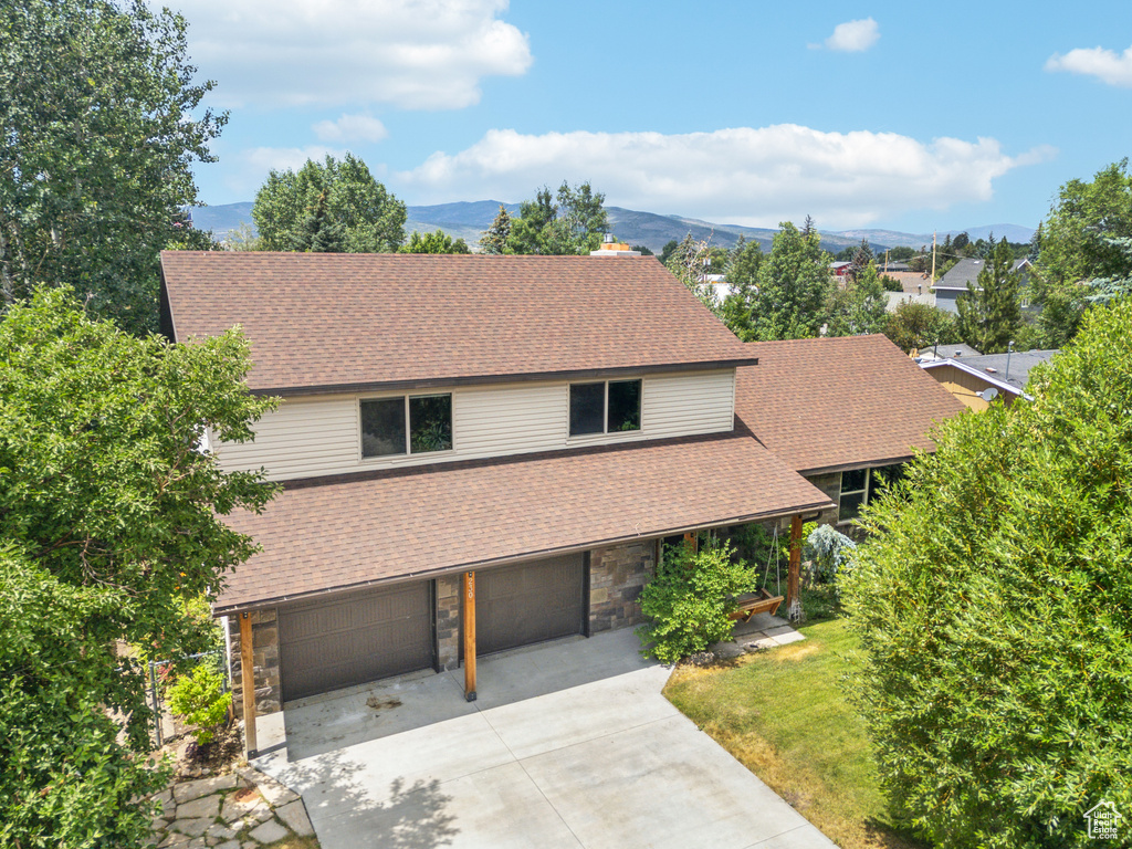 Exterior space with a garage and a mountain view