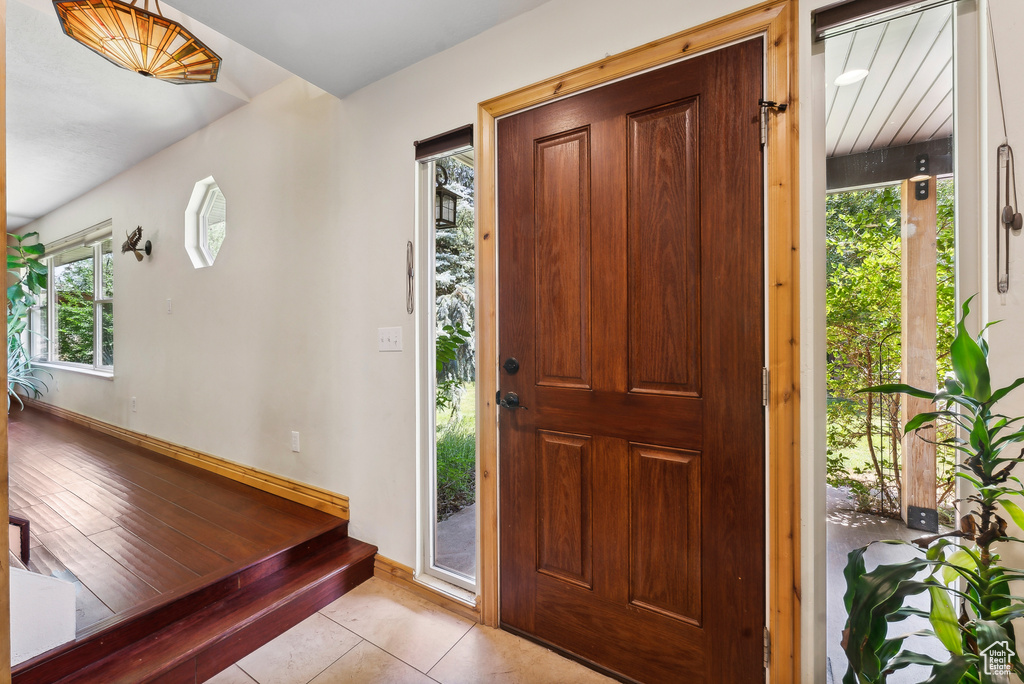 Entryway featuring a healthy amount of sunlight and light tile patterned floors