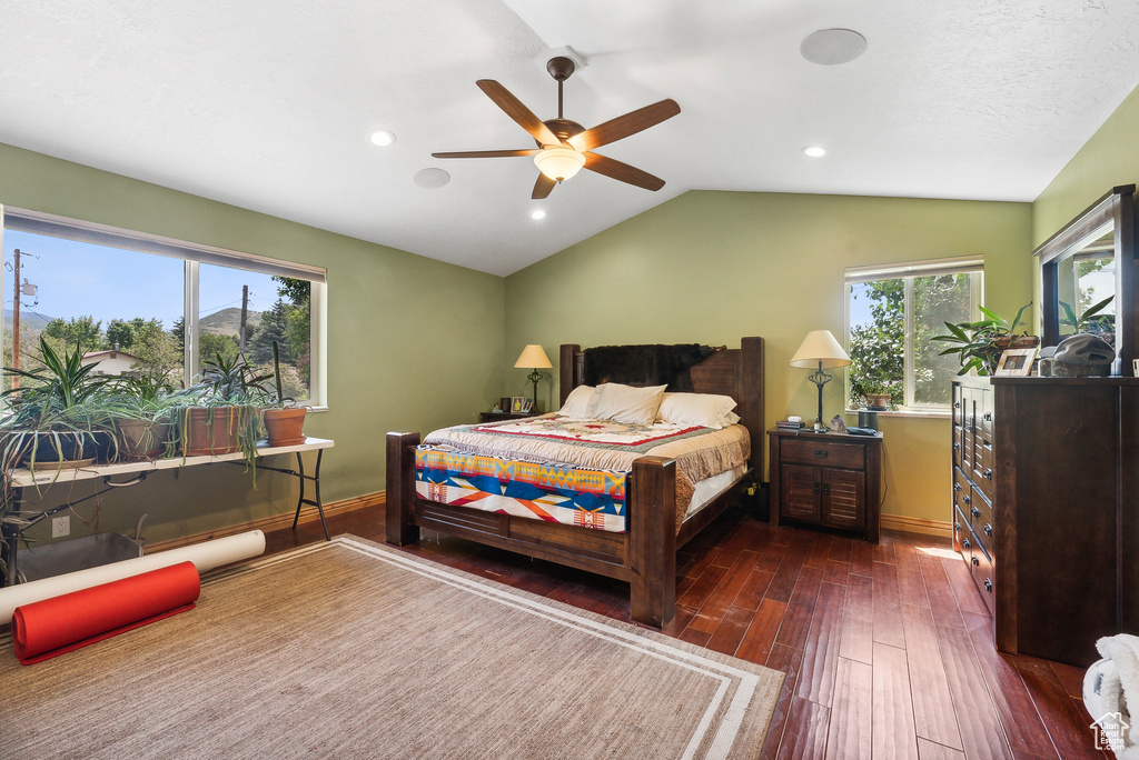 Bedroom featuring lofted ceiling, dark wood-type flooring, and ceiling fan