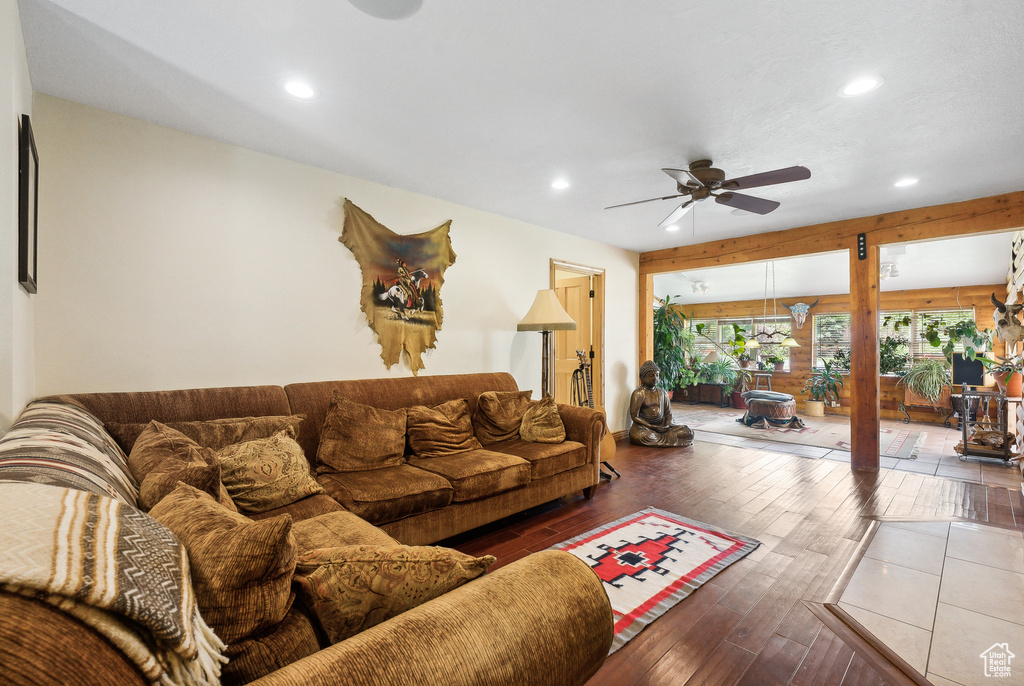 Living room with ceiling fan and hardwood / wood-style flooring