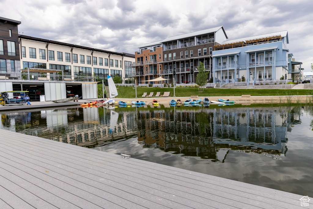 View of dock with a balcony and a water view