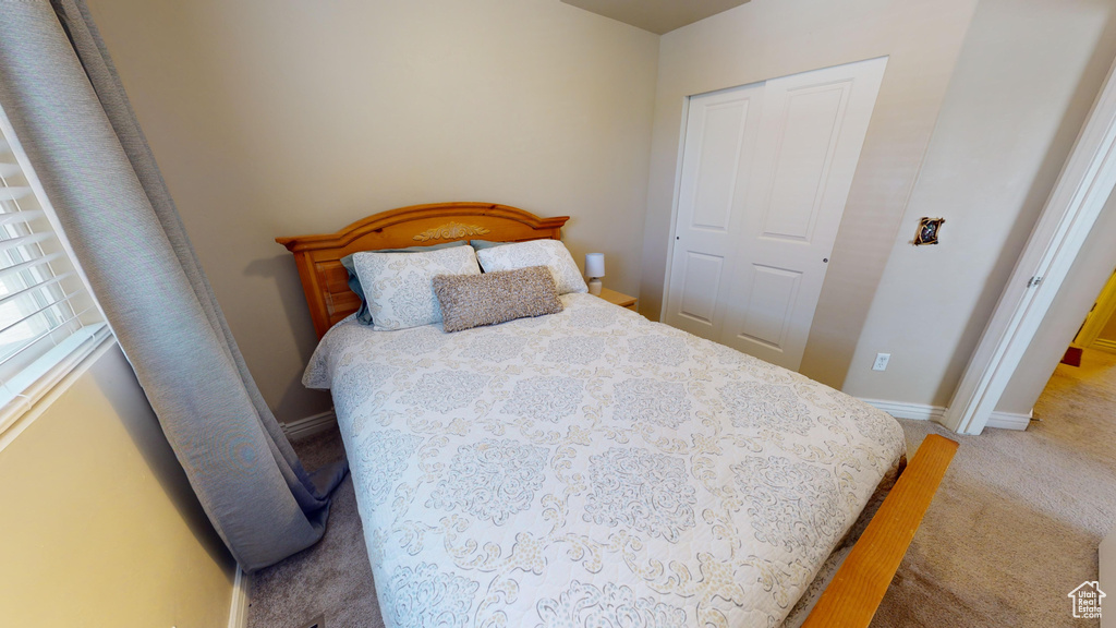 Bedroom with carpet and a closet