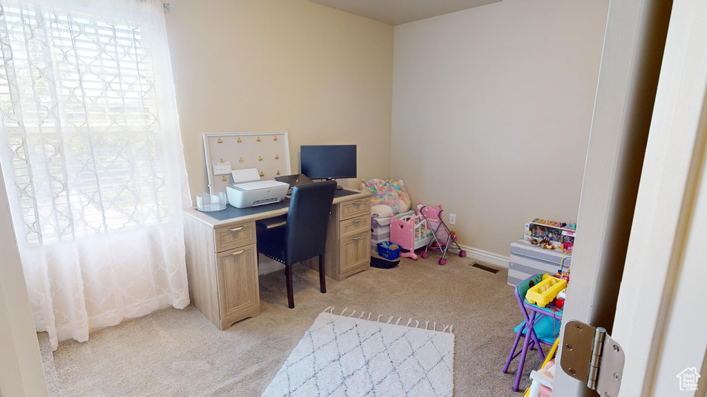 Home office with light colored carpet