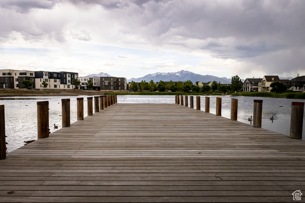 View of dock featuring a water and mountain view