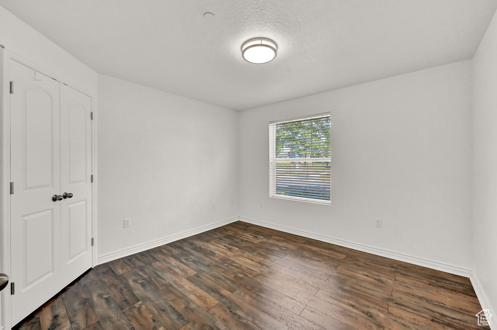 Unfurnished bedroom with a closet and wood-type flooring