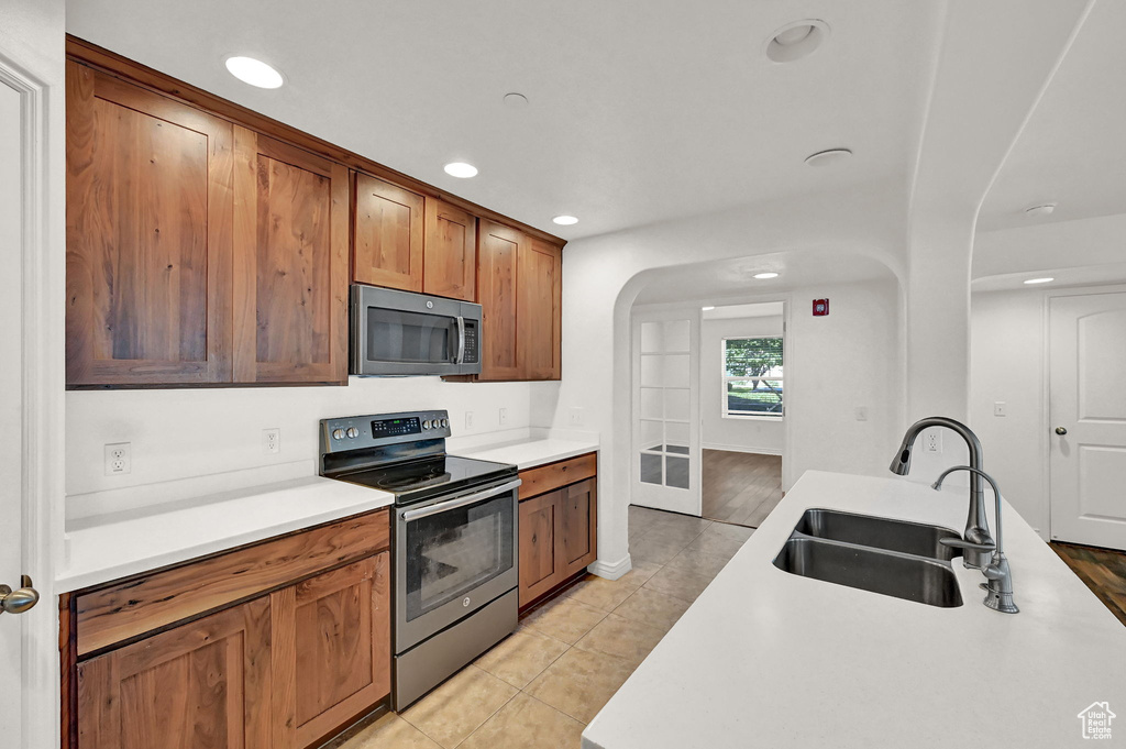 Kitchen featuring light hardwood / wood-style floors, appliances with stainless steel finishes, and sink