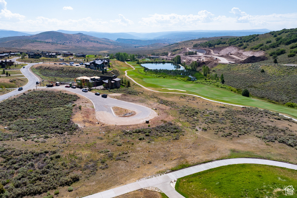 Birds eye view of property featuring a water and mountain view