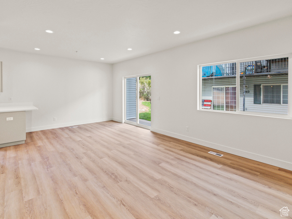 Empty room with light hardwood / wood-style flooring