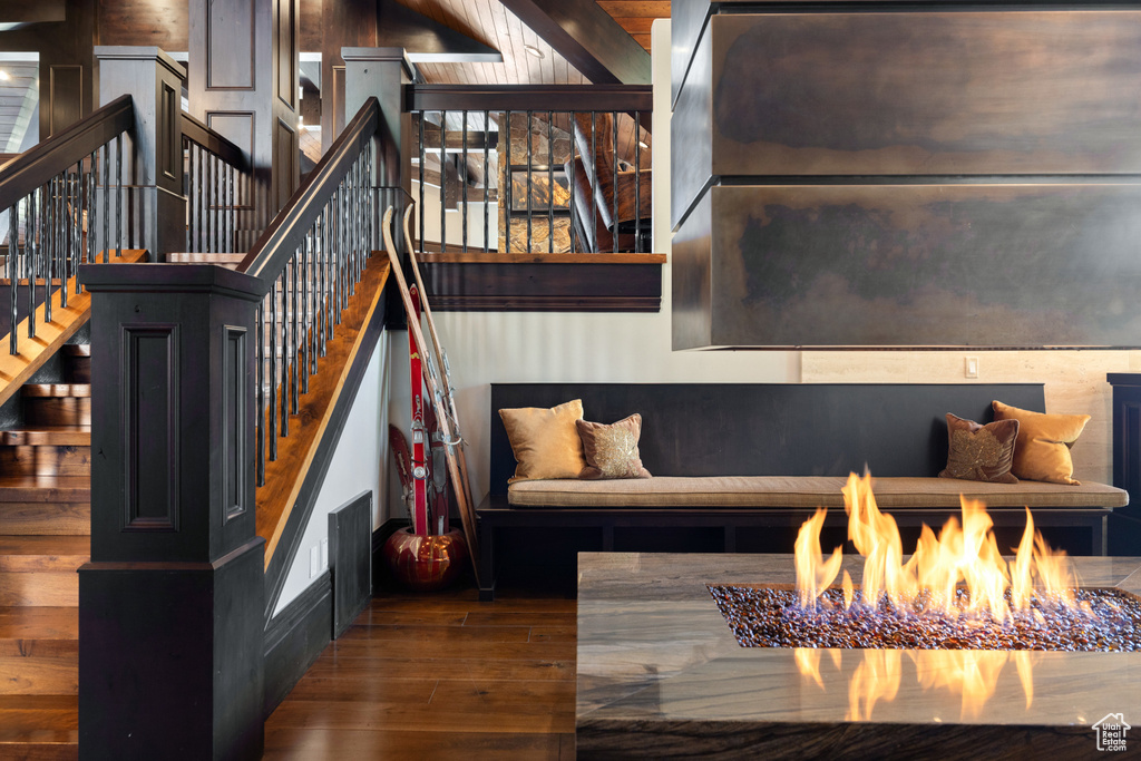 Living room with dark hardwood / wood-style floors and an inviting chandelier