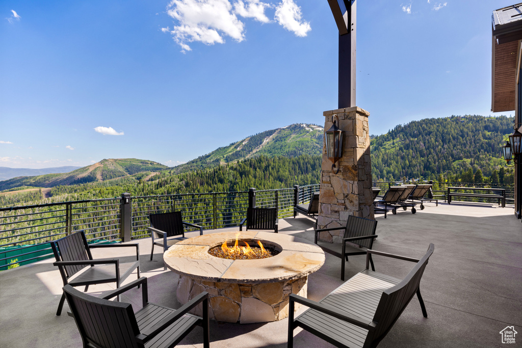 View of patio featuring a mountain view and a fire pit