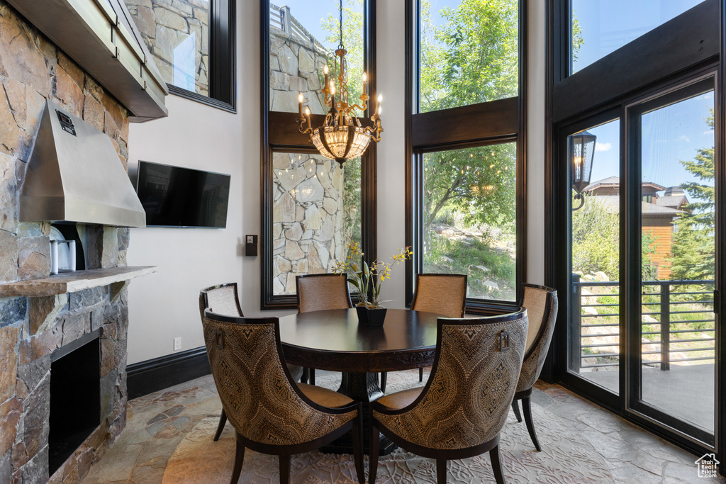 Dining area with a fireplace and a chandelier