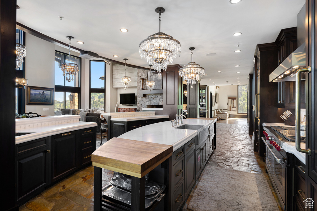 Kitchen featuring ornamental molding, sink, pendant lighting, and plenty of natural light