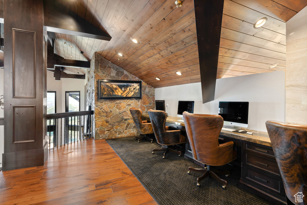 Office with wood ceiling, hardwood / wood-style flooring, built in desk, and vaulted ceiling with beams