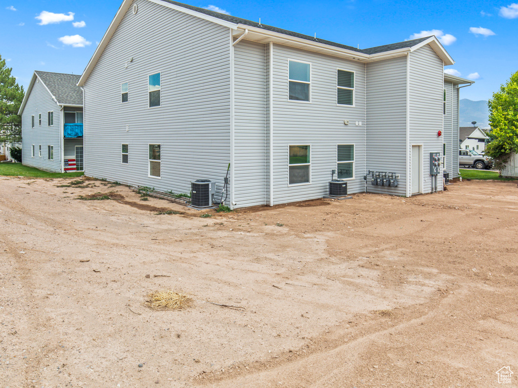 Rear view of house with central air condition unit