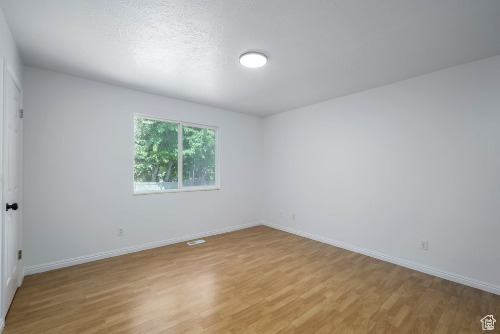 Spare room featuring light wood-type flooring