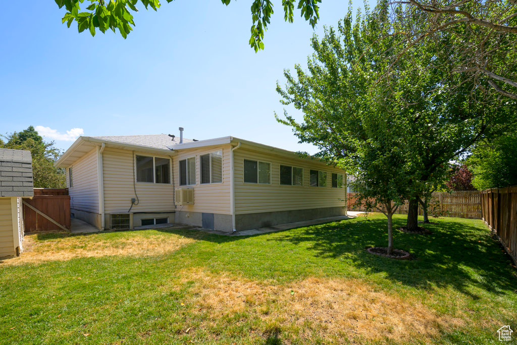 Back of house with a lawn