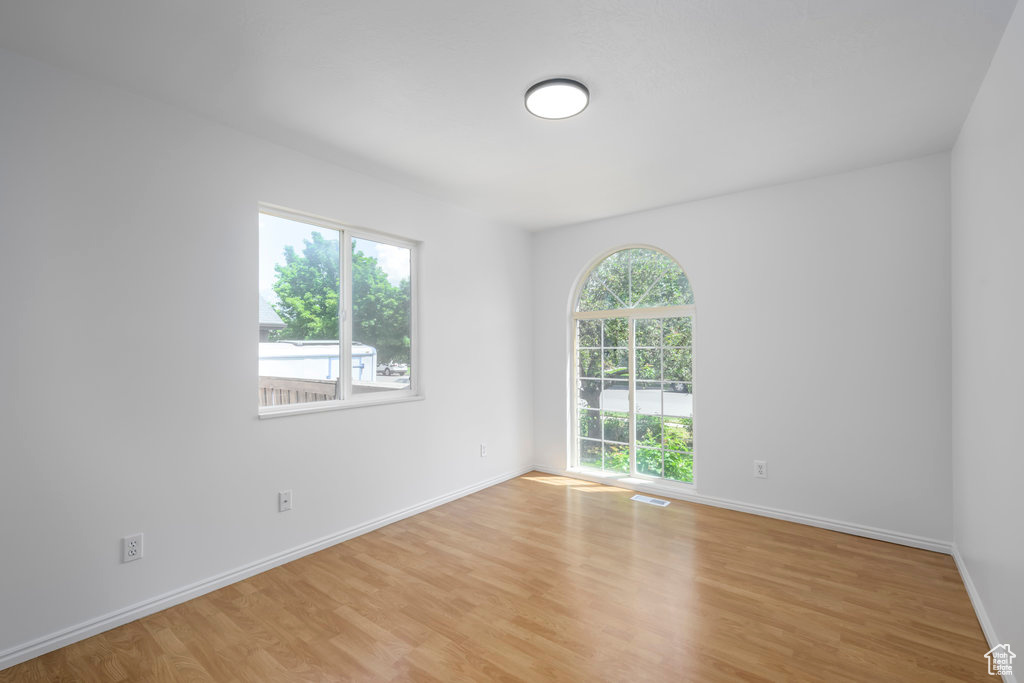 Spare room featuring light wood-type flooring