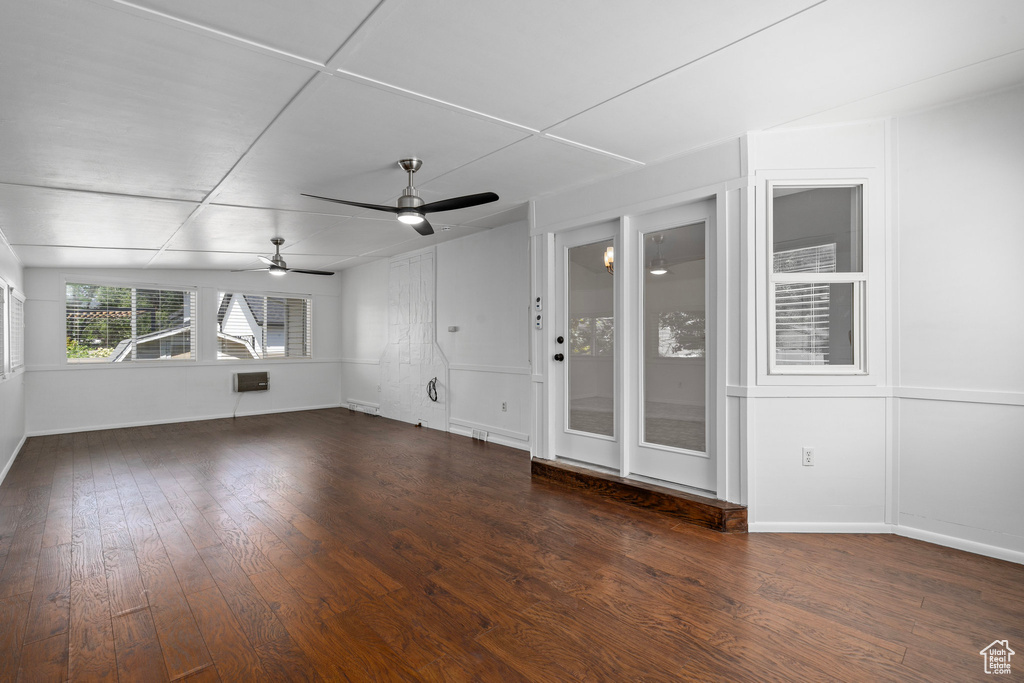 Unfurnished living room with ceiling fan and hardwood / wood-style floors