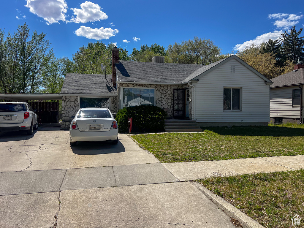 Ranch-style house with a carport and a front yard