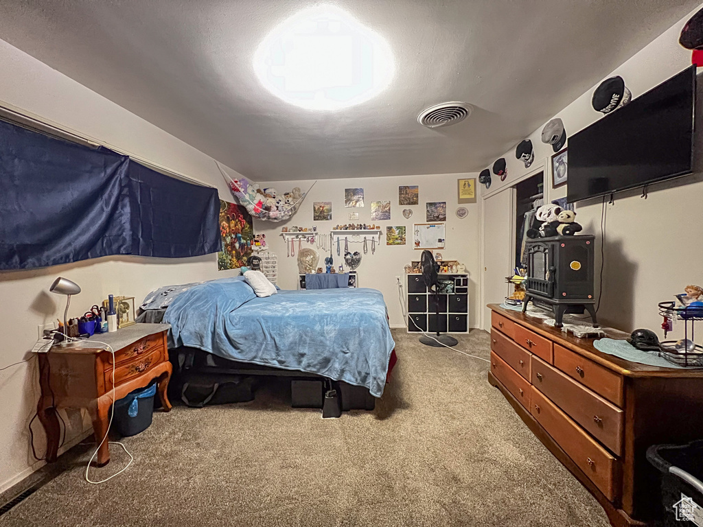 Bedroom featuring light carpet