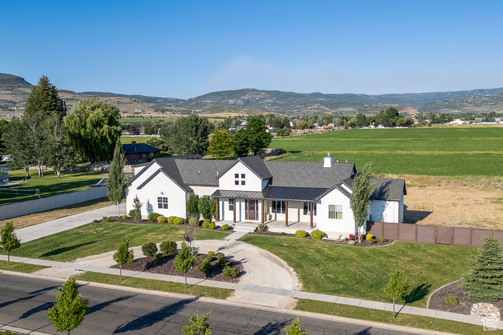 View of front of property with a front lawn and a mountain view