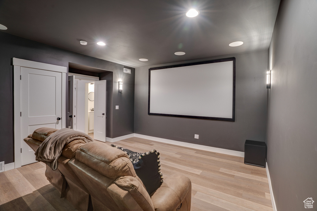 Cinema featuring light hardwood / wood-style floors