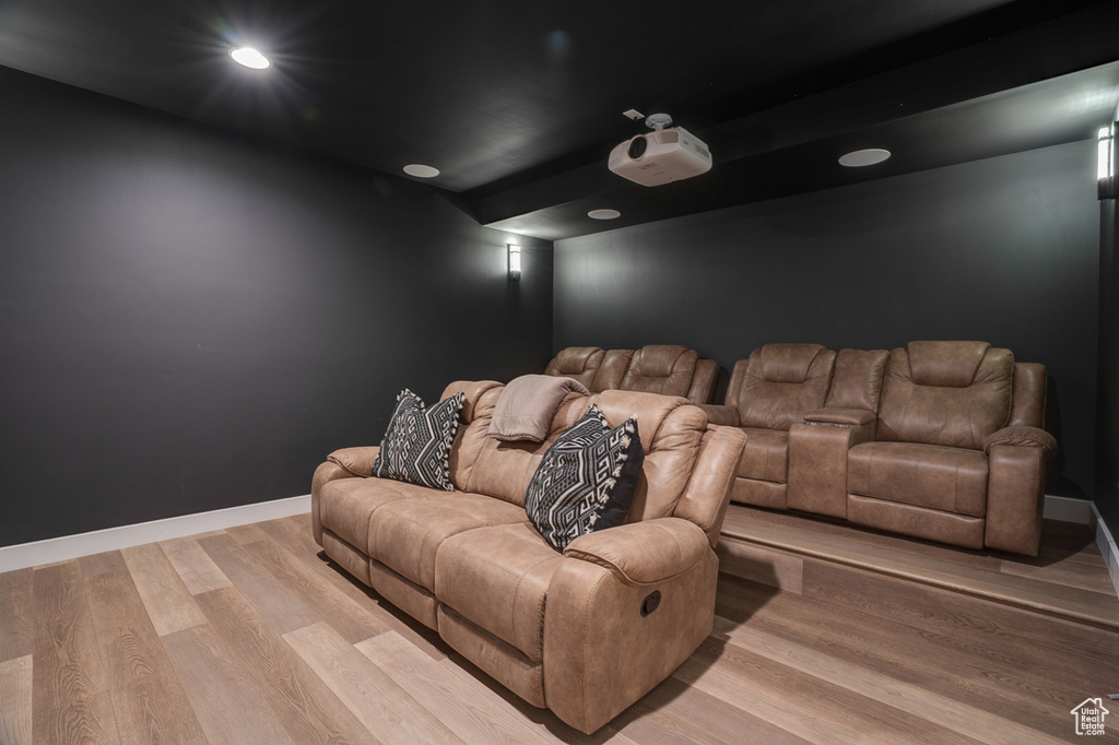 Home theater room with hardwood / wood-style flooring