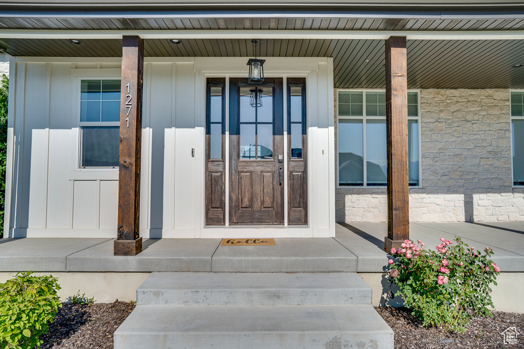 Doorway to property with covered porch