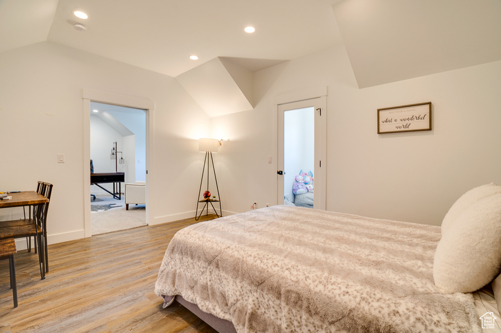 Bedroom featuring vaulted ceiling and light wood-type flooring