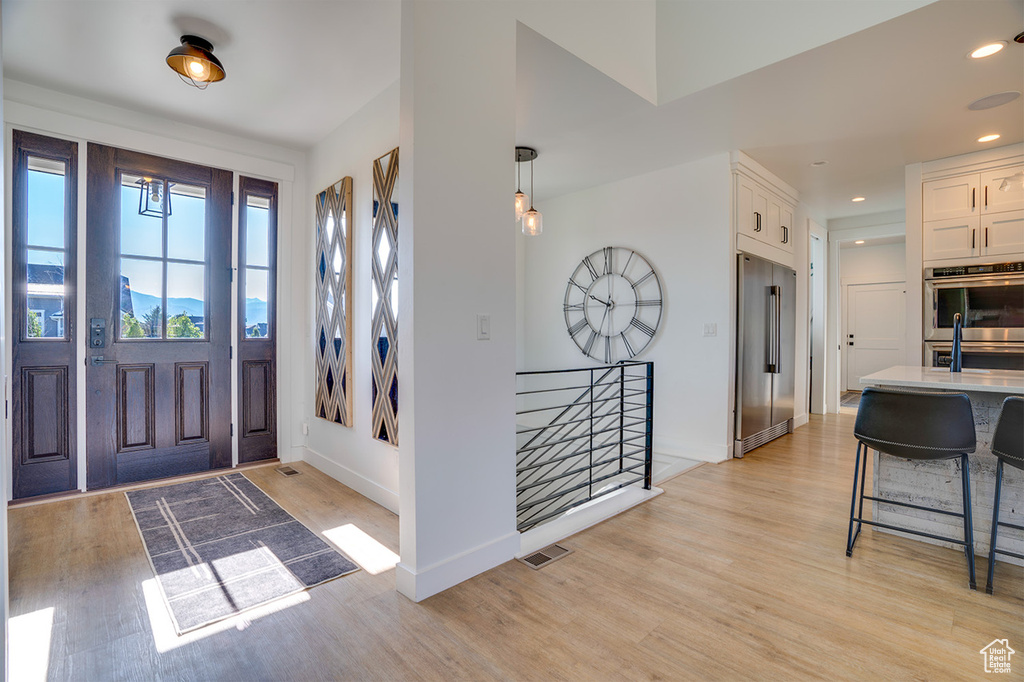 Entrance foyer featuring light hardwood / wood-style flooring