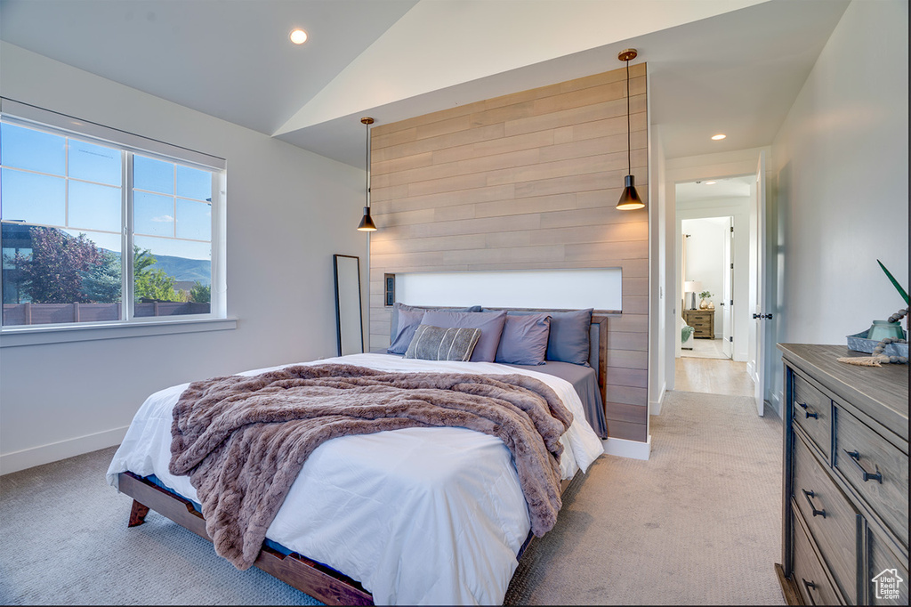 Bedroom featuring lofted ceiling and light colored carpet