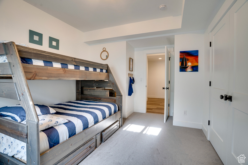 Bedroom featuring light carpet