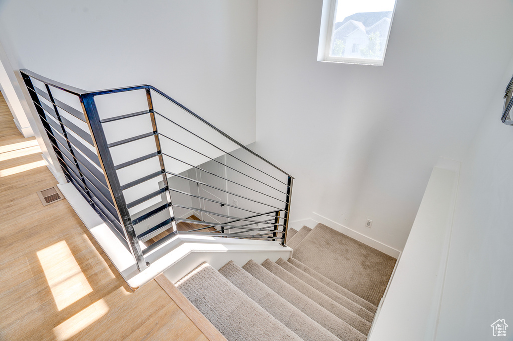 Staircase with hardwood / wood-style floors