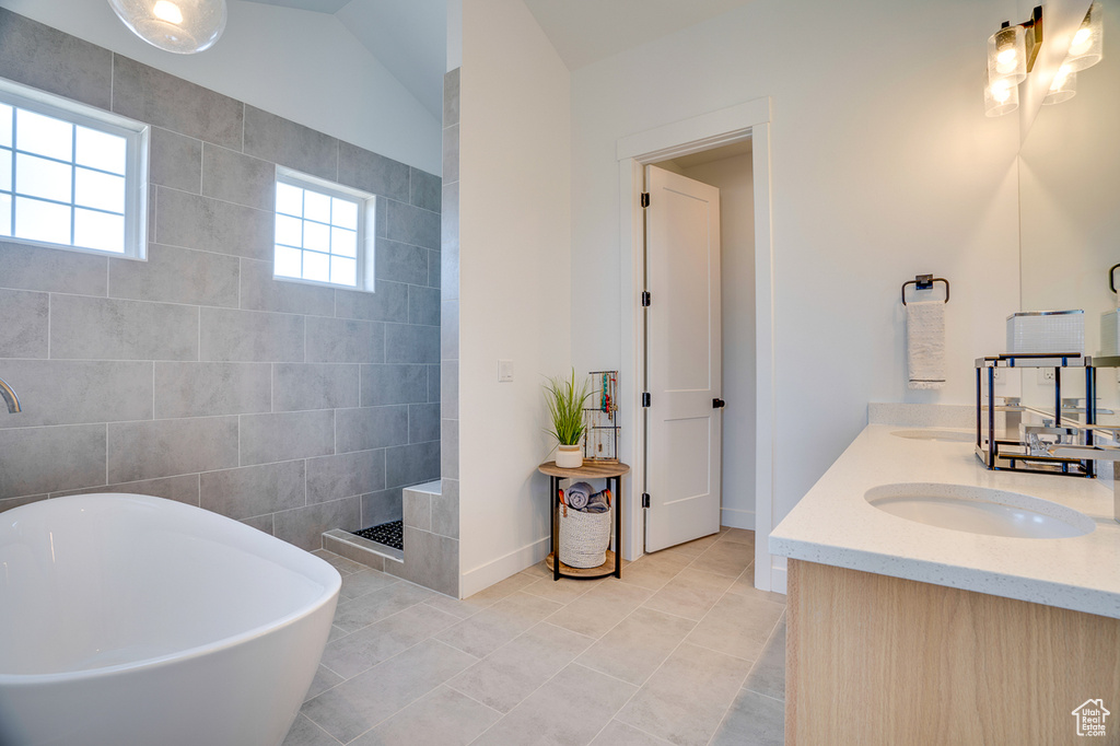 Bathroom featuring vanity, tile walls, independent shower and bath, and tile patterned floors