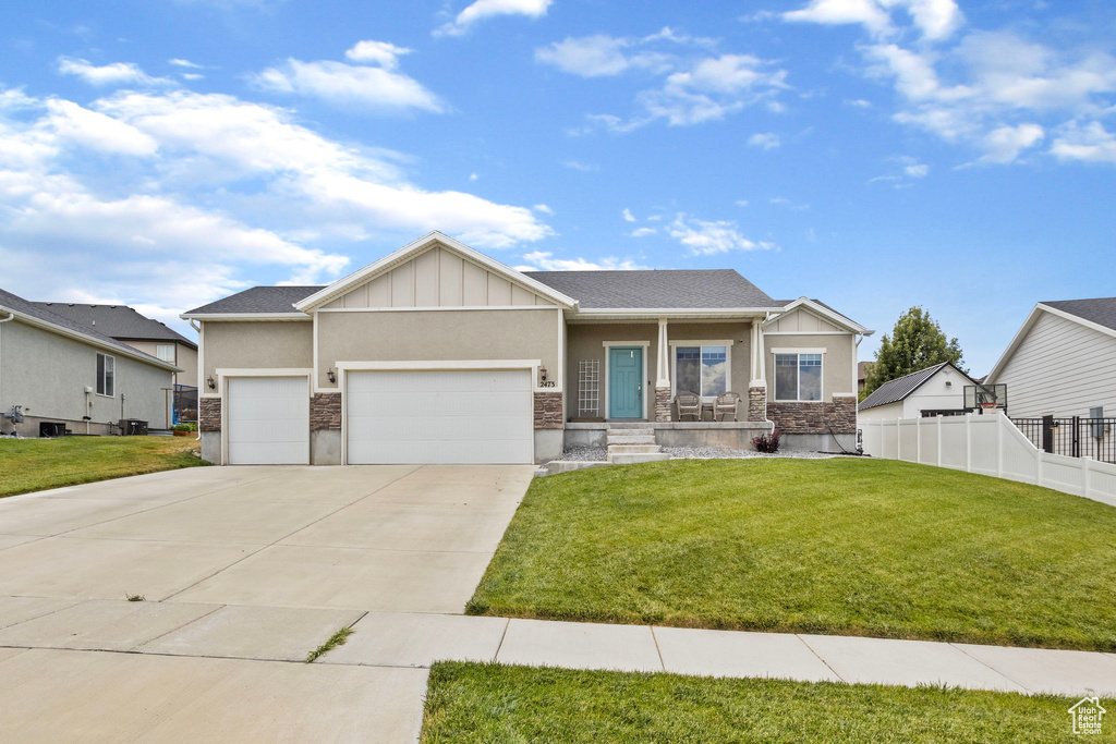 Craftsman-style house with a garage and a front yard