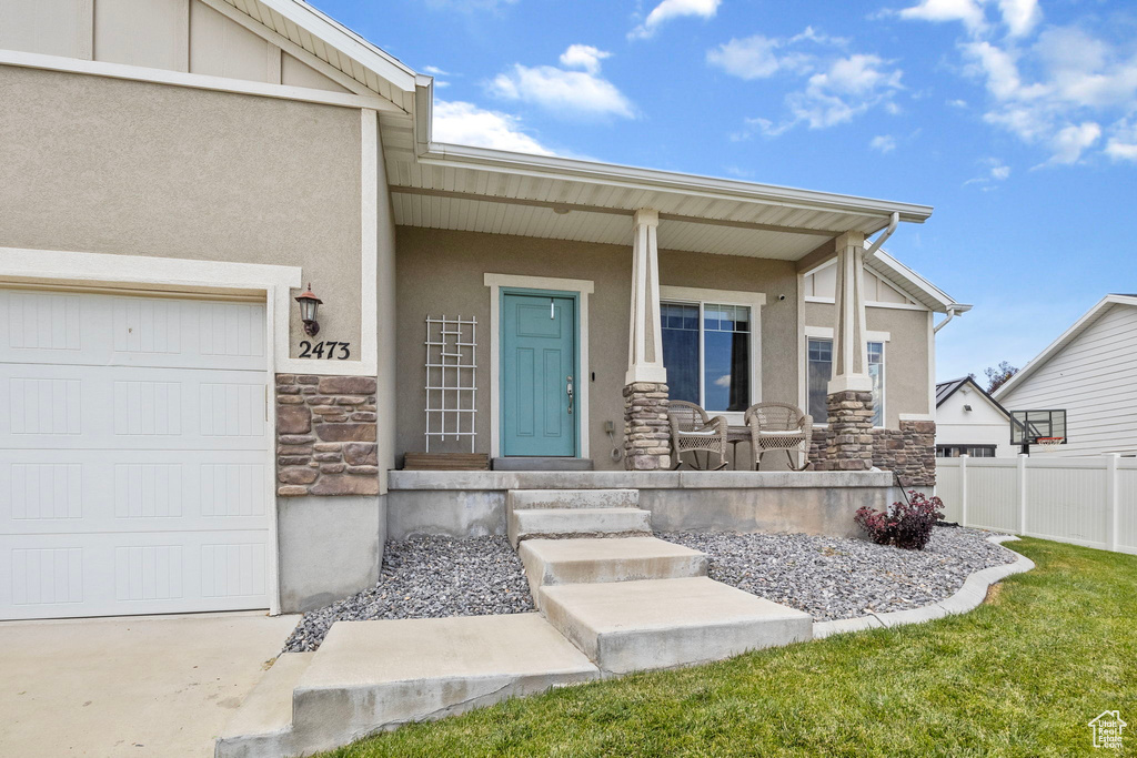 View of exterior entry with a garage