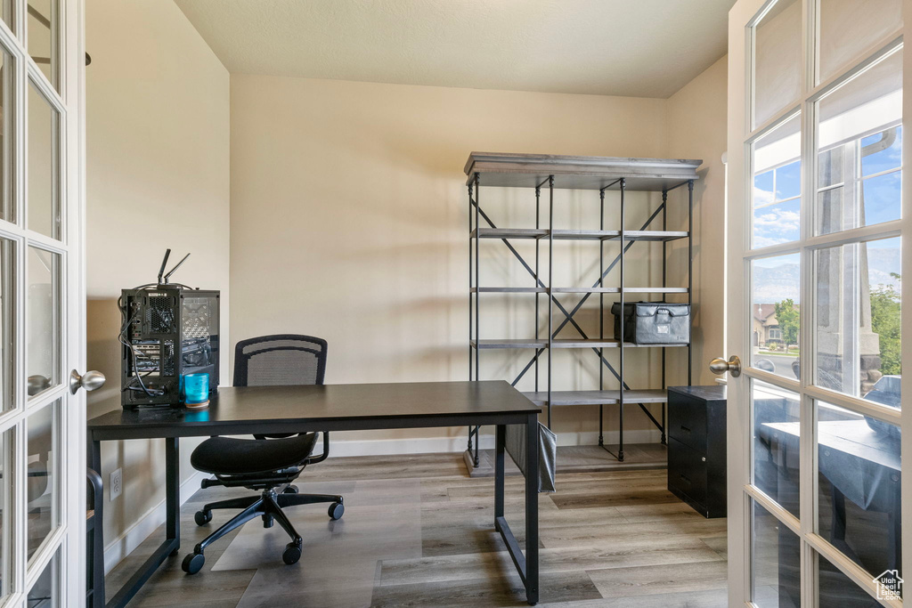 Home office featuring french doors and hardwood / wood-style floors