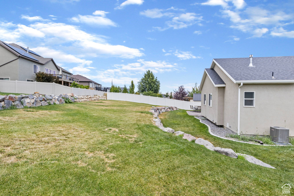 View of yard with central AC unit