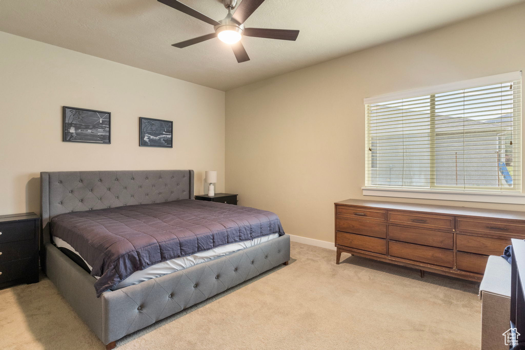 Bedroom with light carpet and ceiling fan