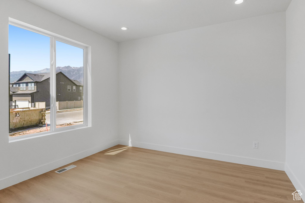 Spare room with light wood-type flooring and plenty of natural light