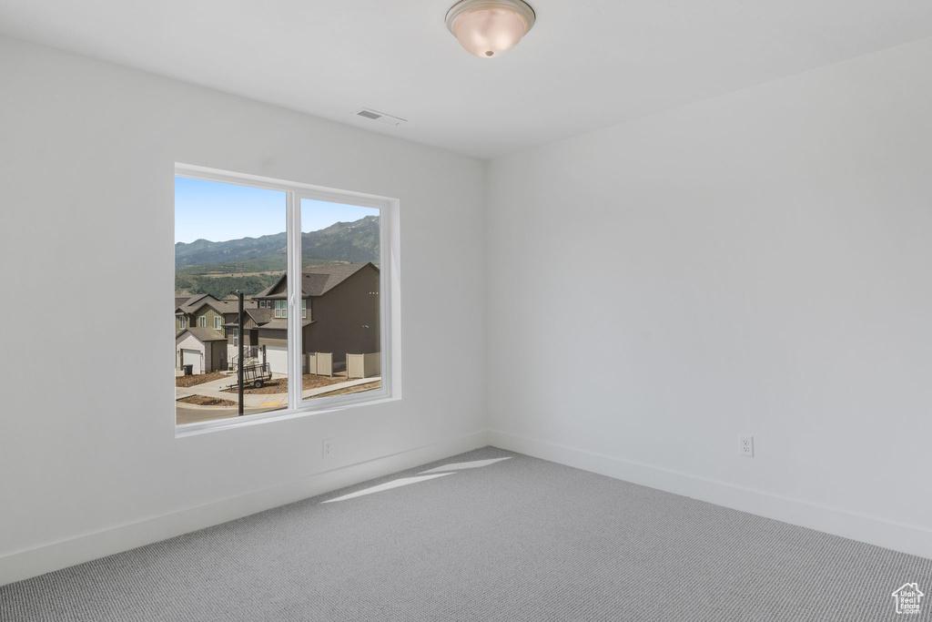 Unfurnished room featuring carpet