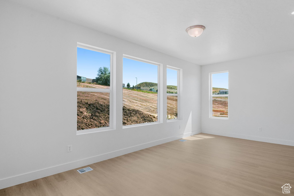 Spare room featuring light wood-type flooring